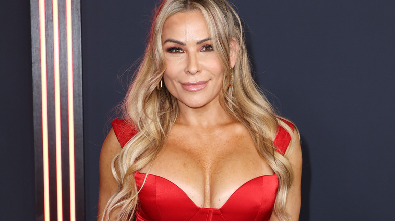 Natalya wearing a red dress