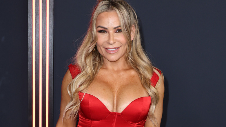 Natalya wearing a red dress