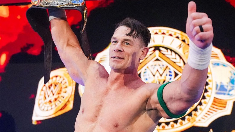 John Cena gives a thumbs up to the fans while standing on the stage with the Intercontinental Championship during an episode of 