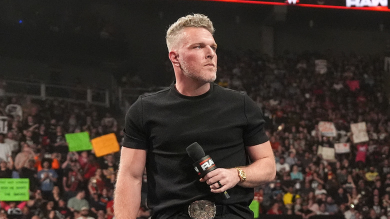 Pat McAfee holds a microphone