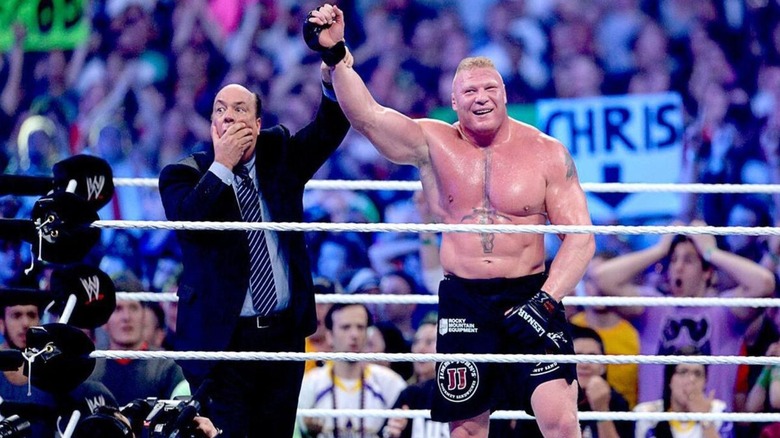 A shocked Paul Heyman raises the hand of Brock Lesnar, after Lesnar defeated The Undertaker's undefeated streak at WWE WrestleMania 30.