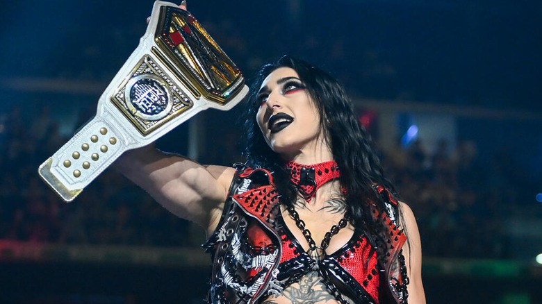 The WWE Women's Champion Rhea Ripley proudly holds up her title before defending it against Jade Cargill at Clash in Italy this past May