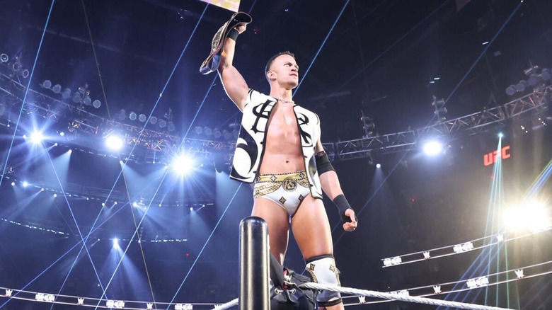 Ricky Saints poses on the ropes, NXT Championship in hand, before a match on 