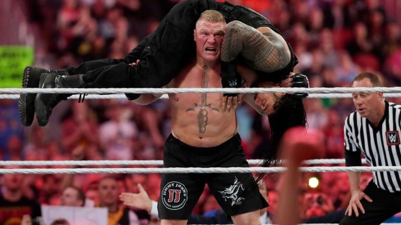Brock Lesnar gets Roman Reigns up for a F5 during their WrestleMania 31 match.
