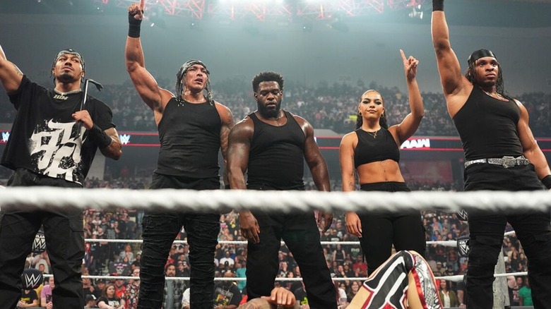 Royce Keys stands alongside 946 stablemates Carmelo Hayes, Bronco Nima, Jaida Parker, and Lucien Price over a downed opponent on an episode of 