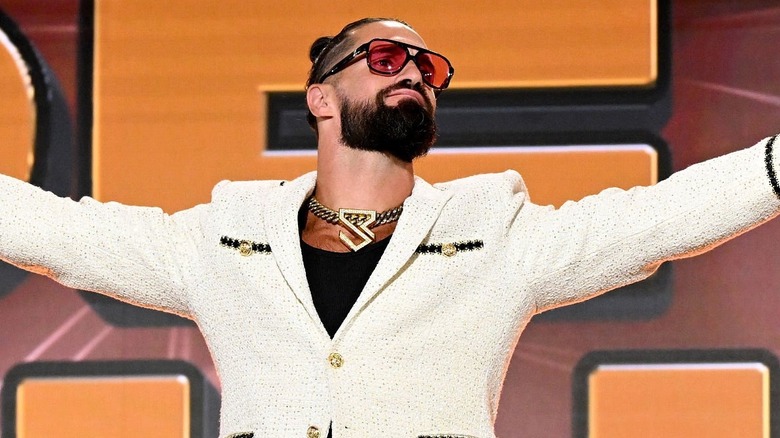 Seth Rollins appears at Fanatics Fest 2025 in a bedazzled white suit.
