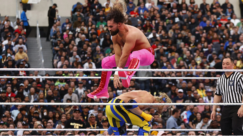 Seth Rollins jumping over Logan Paul
