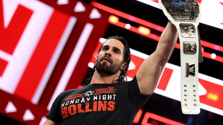 Seth Rollins posing with the WWE Intercontinental Championship during an episode of 