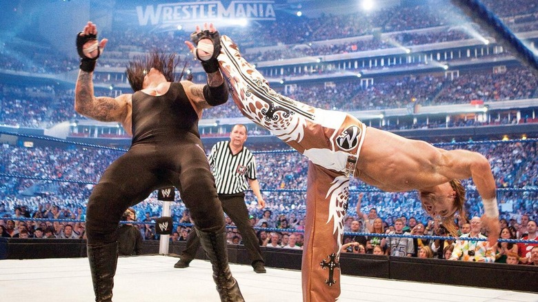 Shawn Michaels hitting The Undertaker with a Sweet Chin Music during their WrestleMania 25 clash.