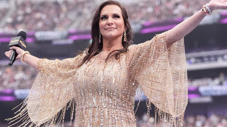 Stephanie McMahon wearing a gold dress