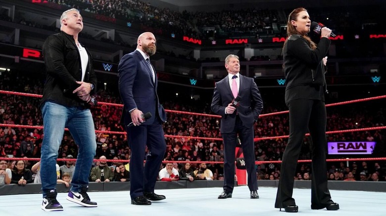 Stephanie McMahon with Shane McMahon, Triple H, and Vince McMahon