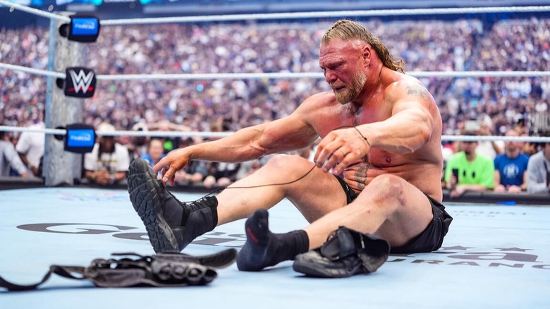 Brock Lesnar sits in the middle of the WrestleMania 42 ring and unties his shoelaces, indicating his final match was now