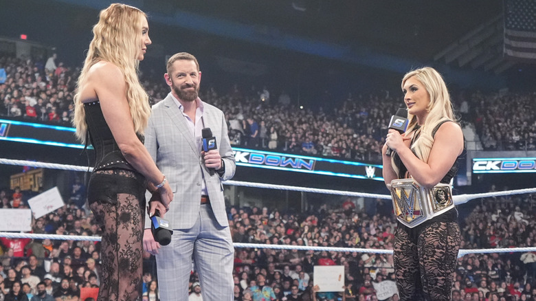 Charlotte Flair and Tiffany Stratton standing in the ring, facing each other