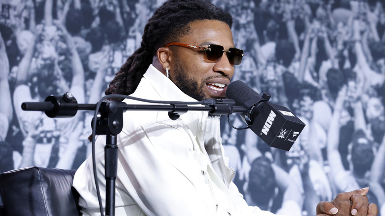 Trick Williams sitting in front of a microphone