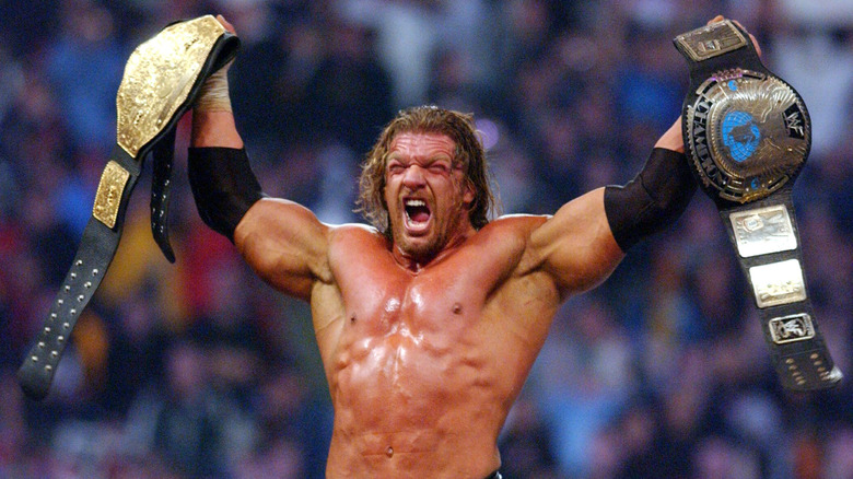 Triple H basks in the glory while holding both the WWE World Heavyweight and Intercontinental Championships at WrestleMania