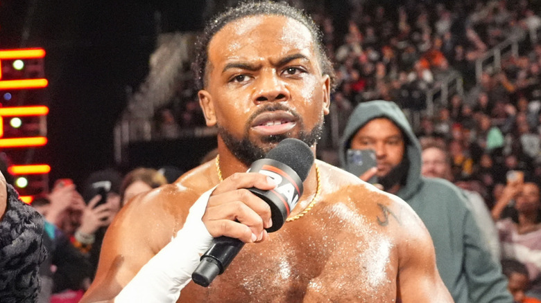 Xavier Woods holding a microphone