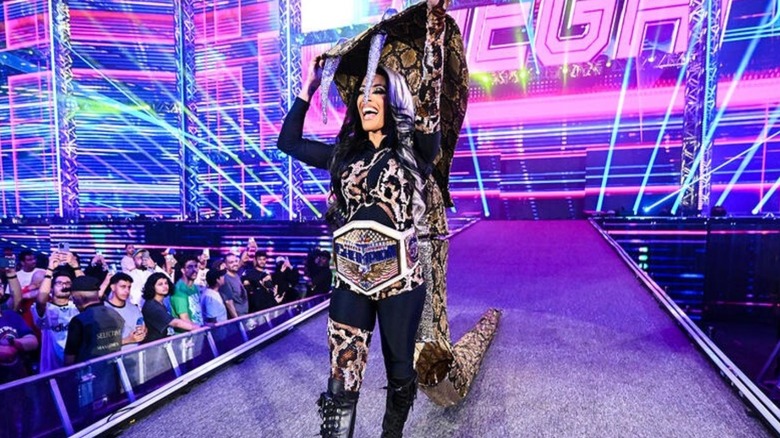 WWE Women's United States Champion Zelina Vega heads down to the ring, wearing gear inspired by a cobra, for a title match on an episode of 