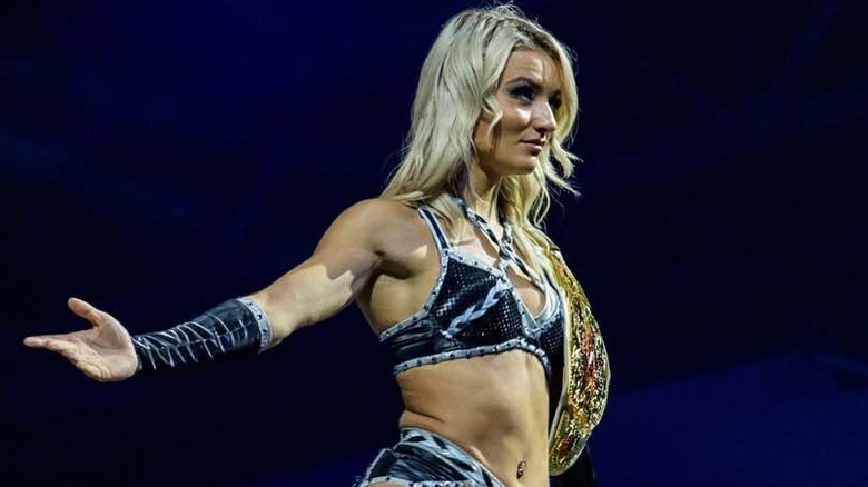 Xia Brookside looks out into the crowd with her TNA Knockouts World Championship around her shoulder