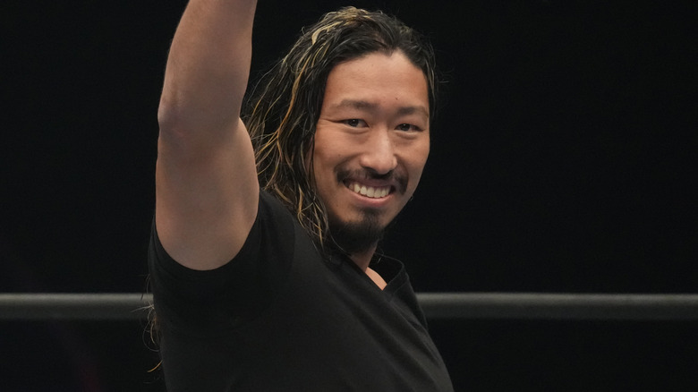 Yota Tsuji smiling with his arm in the air