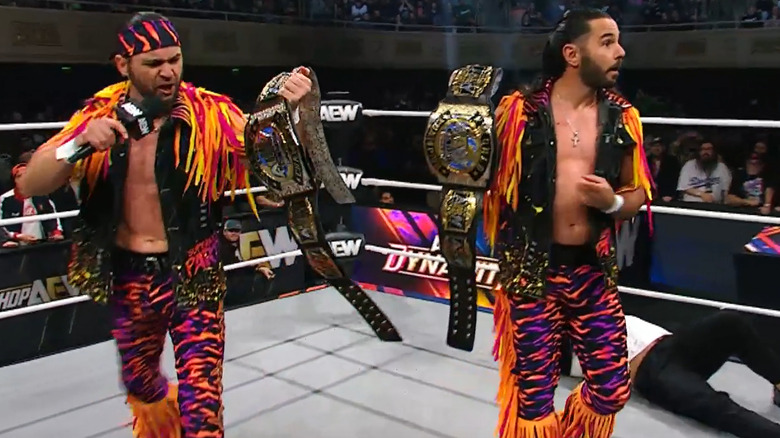 The Young Bucks hold FTR's Tag titles in the ring