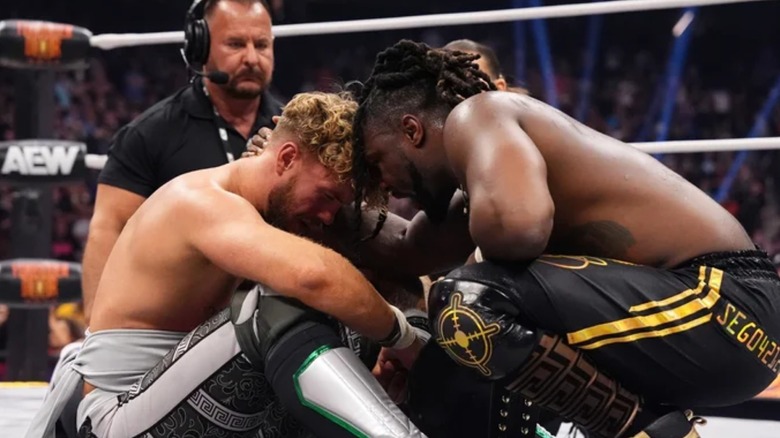Will Ospreay and Swerve Strickland embracing