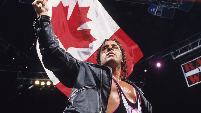 Bret Hart raises the Canadian flag in the ring before a match on "WWE Raw."