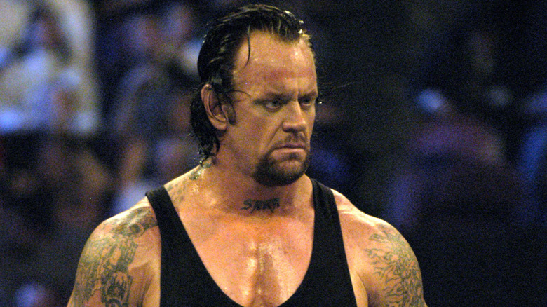 The Undertaker stares down his opponent in the ring during a match.