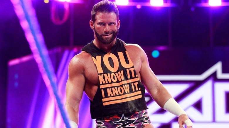 Zack Ryder smirks as he makes his purple-lit entrance.