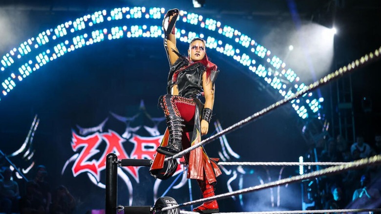 Women's North American Champion Zaria poses, with her title in hand, on the ropes before a match on an episode of 